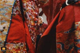 In Kaifeng, Henan, China, the bride and groom deeply bow to the groom's grandmother, who is visibly moved to tears by the respectful gesture.
